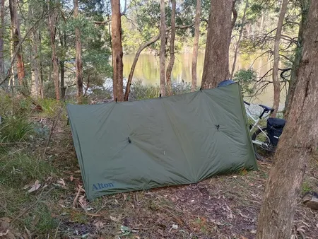 Campsite with tarp set up like an a-frame